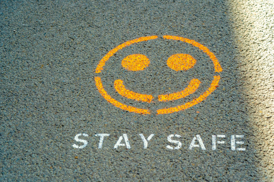 smiley face on ash felt with words stay safe painted under